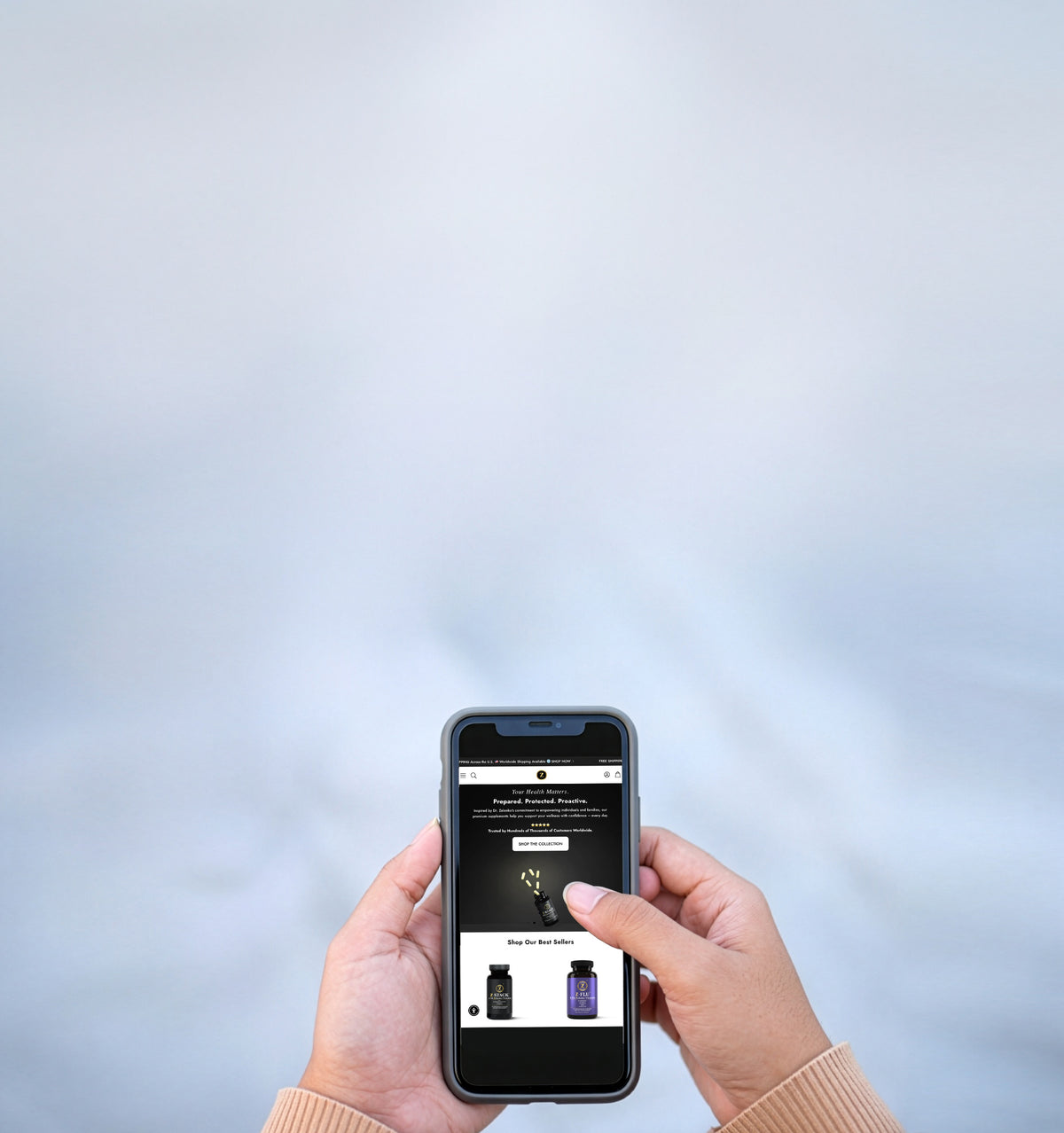 woman hands holding a mobile smartphone with zelenko website on screen