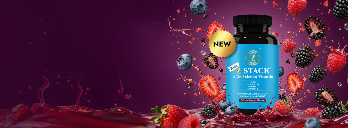 blue bottle of kids z-stack with berries and juice splashing around it on purple background