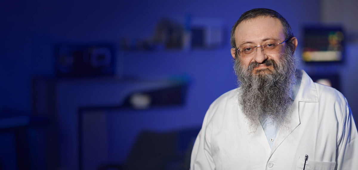 Doctor Zelenko, a man with a beard and glasses wearing a suit against a dark background